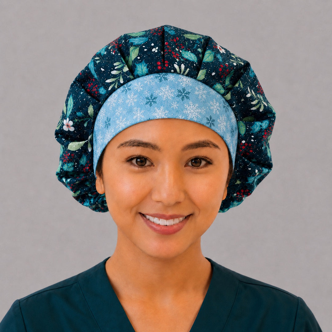 Woman wearing a winter holly bouffant scrub cap, front view — glitter holly and red berries on navy with ice-blue snowflake band, adjustable women&