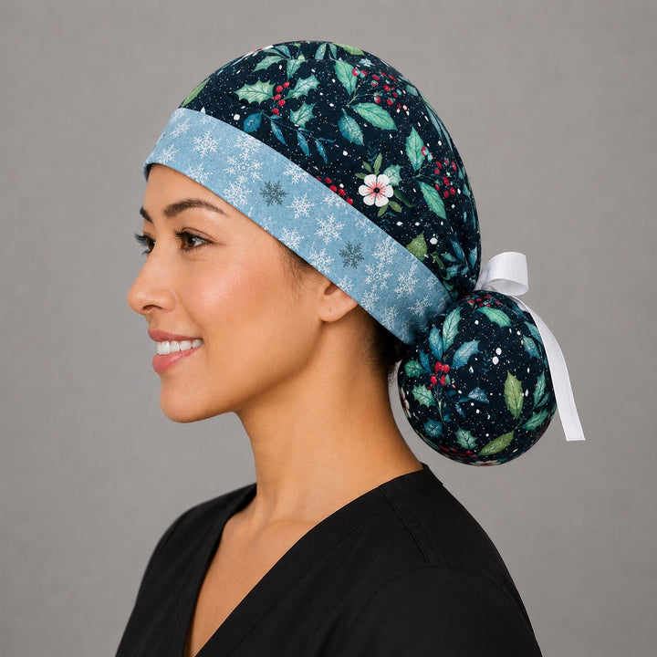 Winter holly ponytail surgical cap left side profile showing gathered ponytail pouch of glittery holly and red berries with snowflake band and white ribbon tie