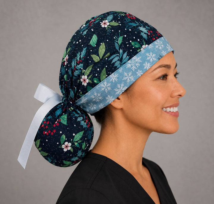 Winter holly ponytail scrub cap right side profile showing gathered pouch of glittery holly and red berries on navy with snowflake band and white ribbon tie