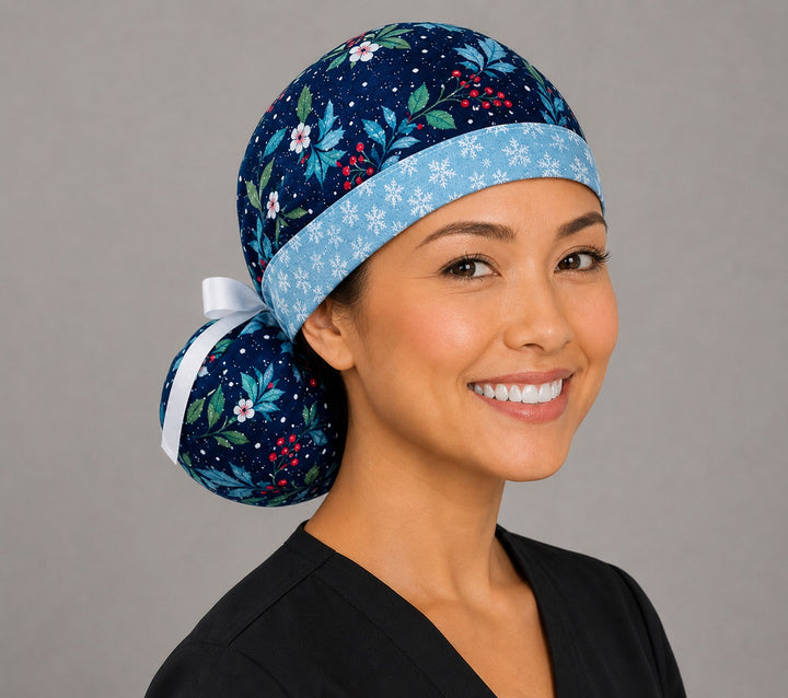 Winter holly ponytail nurse cap right three-quarter angle on smiling model showing glittery holly, red berries and blue foliage with snowflake band and white ribbon bow
