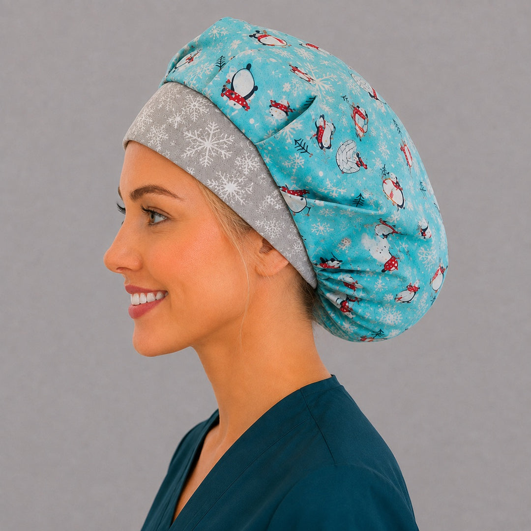 Back view of the winter penguin bouffant scrub cap — penguins, igloos, hot chocolate and snowflakes across the full aqua crown