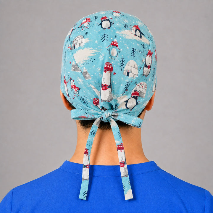Back view of adjustable tie-back knot on aqua winter penguin unisex surgical hat