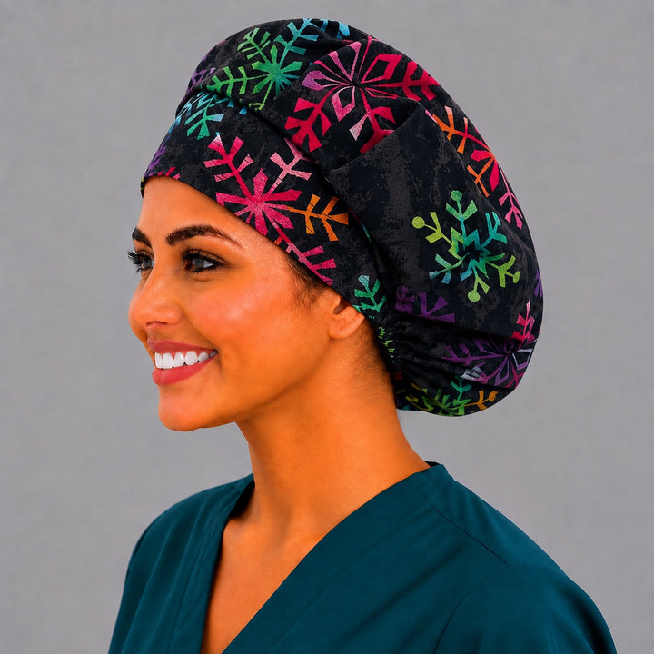 Winter snowflake bouffant scrub cap, left side profile — vivid rainbow snowflake print for OR nurses and surgical techs