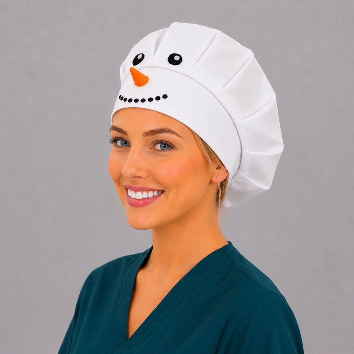 Winter white snowman bouffant scrub cap left front angle on smiling model showing 3D snowman face and orange carrot nose, women&