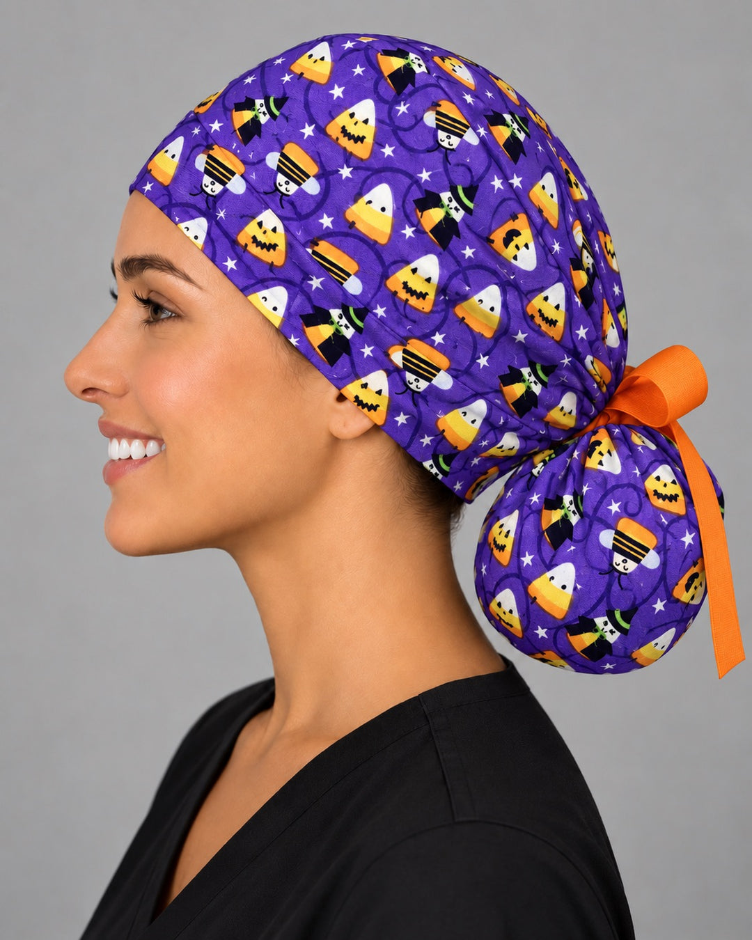Witch and candy corn ponytail cap, right side view — purple Halloween print with gathered ponytail pouch