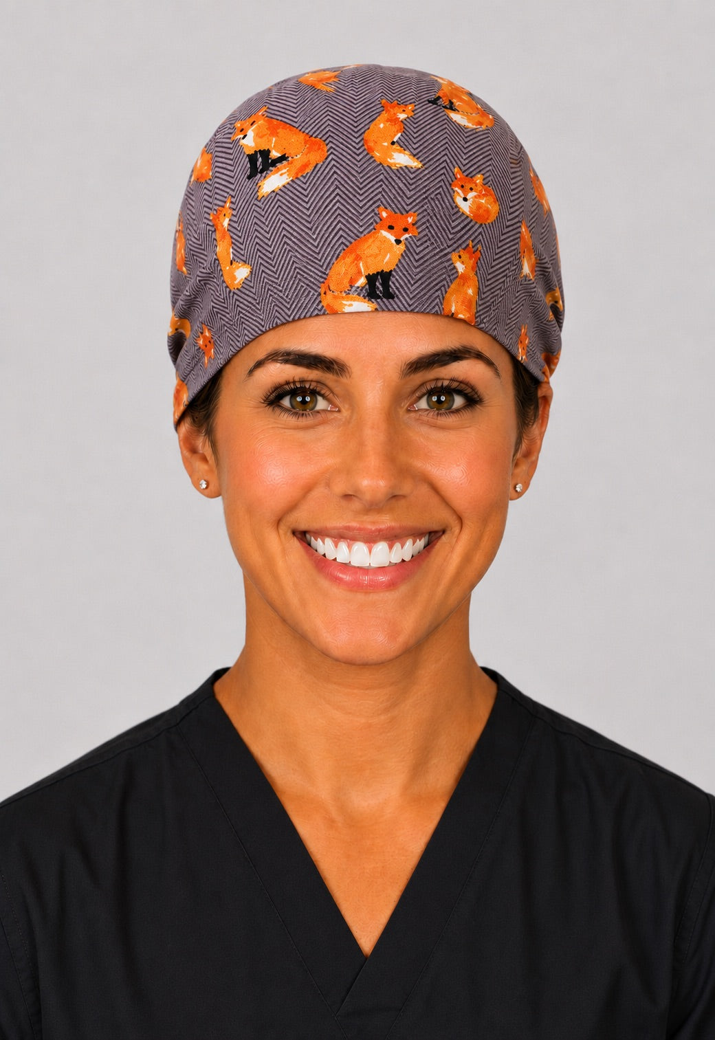Woodland fox scrub cap for short hair, handmade gray herringbone tie-back surgical hat with orange foxes on OR nurse, front view
