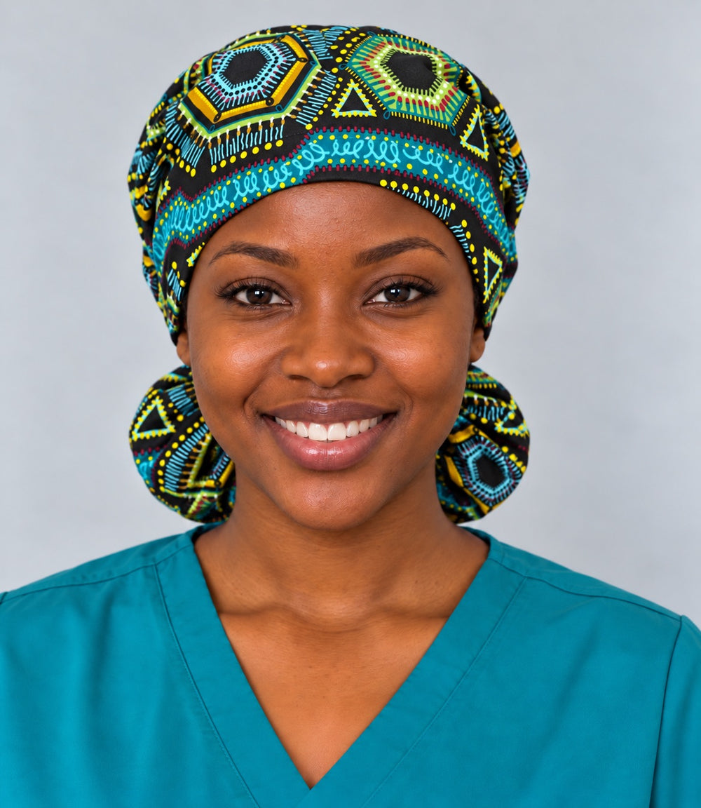 Front view of an XL African print ponytail scrub cap on a smiling nurse, with a turquoise swirl stripe running across the forehead band beneath gold and lime hexagons