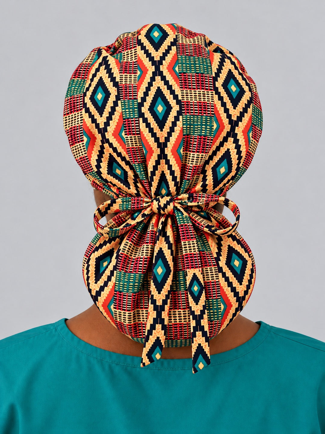 Back view of an XL Kente ponytail nurse hat, with diamonds stacked down the crown, full rear coverage and long ties falling over the pouch