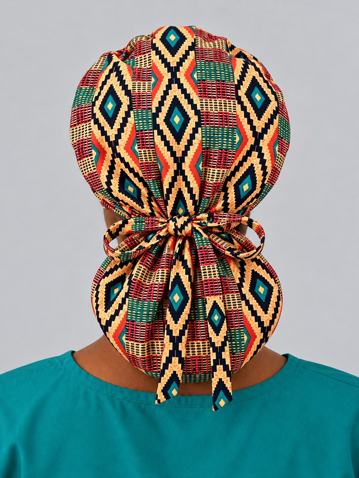 Back view of an XL Kente ponytail nurse hat, with diamonds stacked down the crown, full rear coverage and long ties falling over the pouch