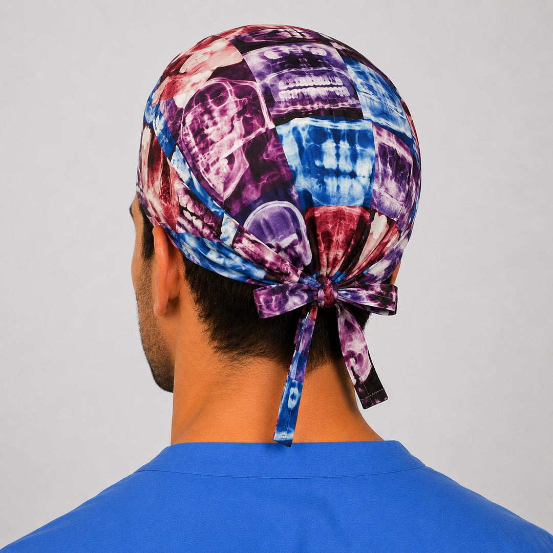 Back view of the X-ray print tie-back scrub cap showing the bow tie closure and full radiograph collage