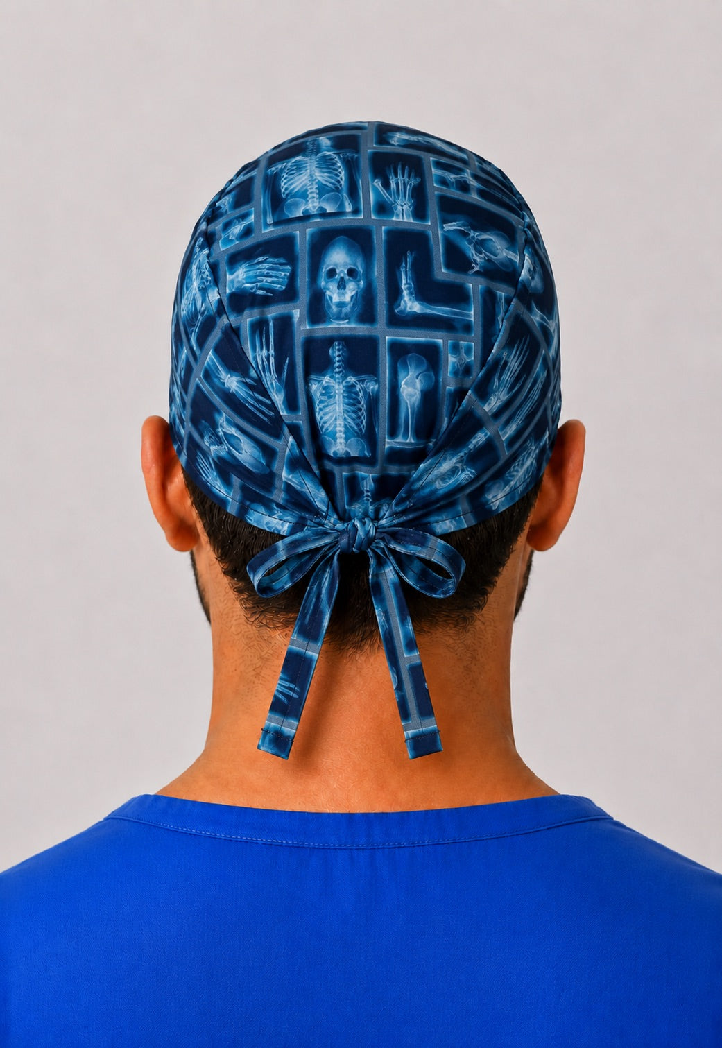 Back view of blue x-ray skeleton scrub cap showing adjustable tie-back closure — radiology tech nurse cap gift by OR World.