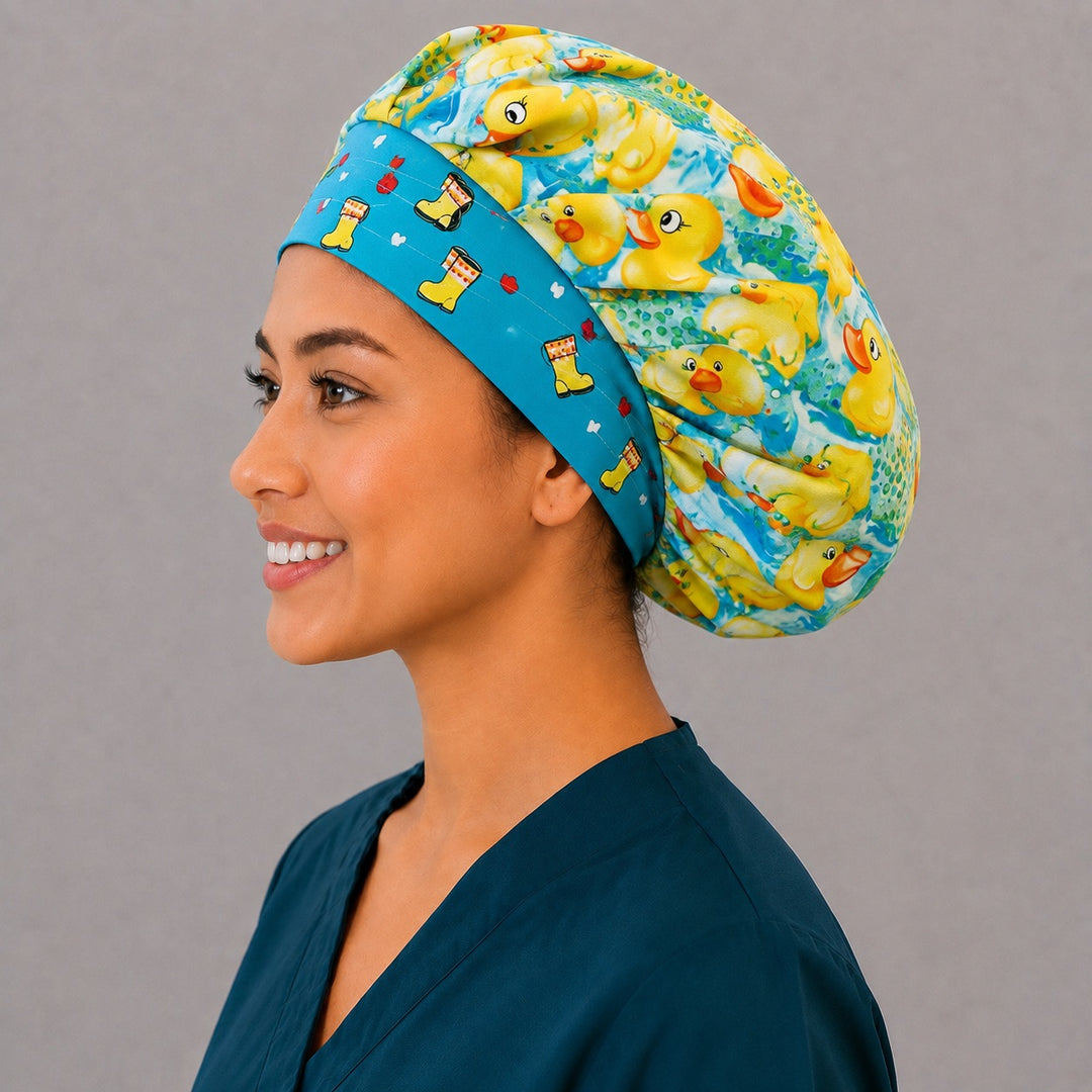 Left side profile of the yellow duck bouffant surgical hat — aqua rain boot contrast band, roomy breathable cotton cap for pediatric nurses