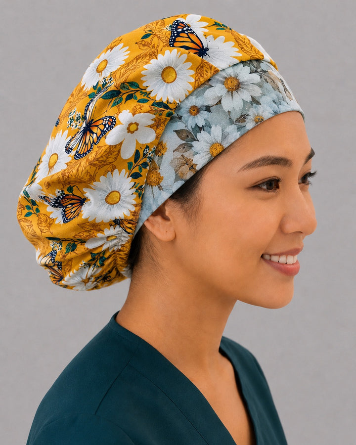 Yellow floral butterfly bouffant scrub cap, left angled view — roomy elastic-back cap that secures long thick or braided hair