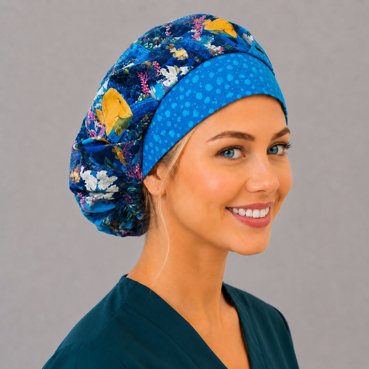 Yellow tang fish bouffant scrub cap, right angled smiling view — vivid ocean print for OR nurses and surgical techs
