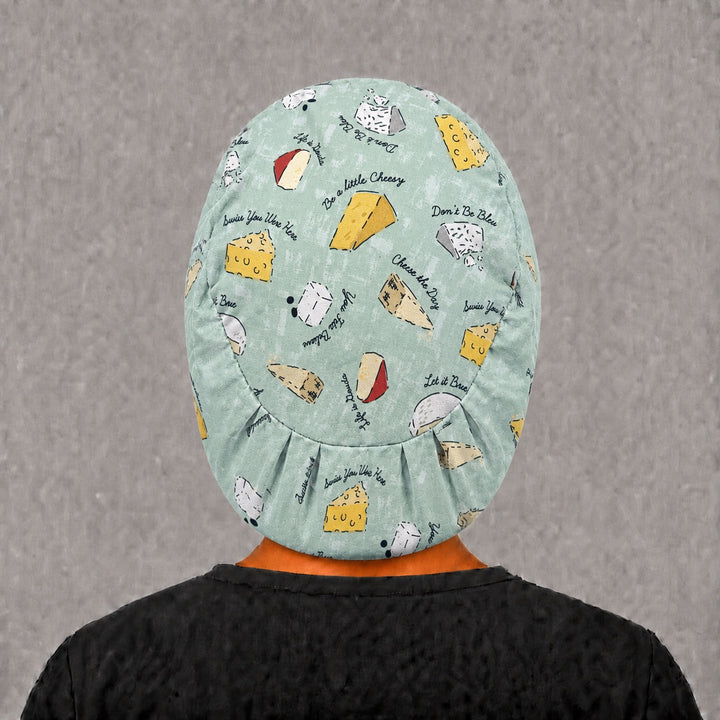 You Feta Believe Euro surgical cap, left angled view — elastic adjustable back with full head coverage for long hair