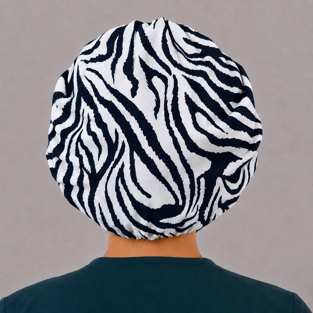 Back view of the zebra bouffant scrub cap — full gathered fit showing bold black and white zebra stripes