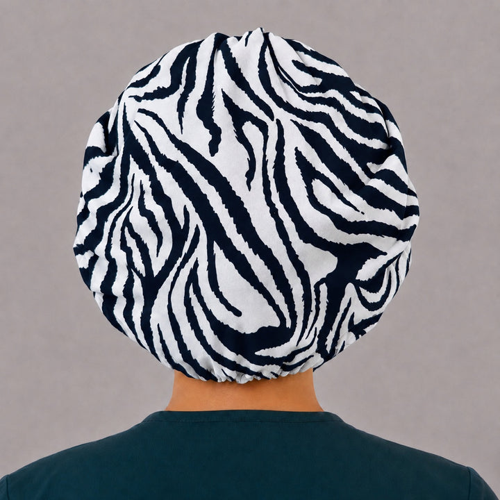 Back view of the zebra bouffant scrub cap — full gathered fit showing bold black and white zebra stripes