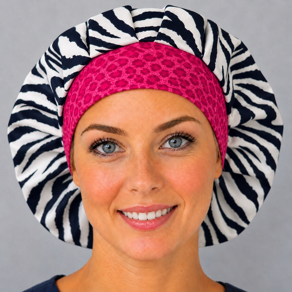 Woman wearing a zebra print bouffant scrub cap, front view — black and white stripes with a hot pink cheetah band, adjustable women's surgical hat