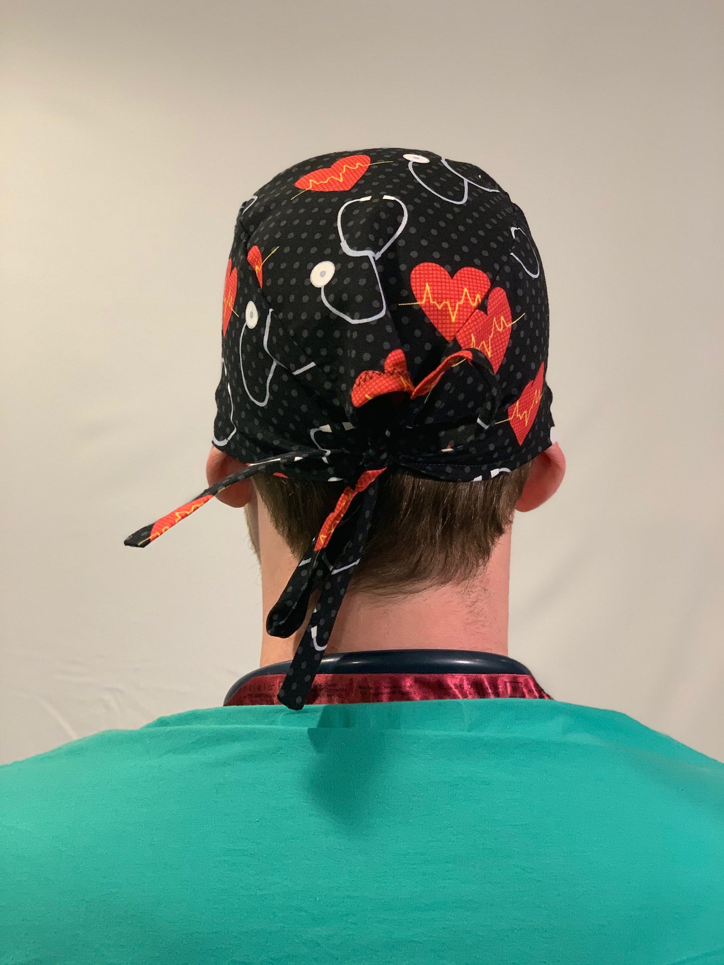 Scrub Cap-Men-Simple-Black-Stethoscope-Saving The Day OR World LLC Surgical Caps-Hats-Scrub Caps-Bouffants-Fun patterns for OR Nurses-Surgical Nurses-Scrub Techs-Surgical Technologists-Technicians-Dentistry-Food Production-Cancer Patients and other medical professionals!   Scrub Cap-Offers a unique, gender neutral design that wraps around head with the ability to tie string in multiple variations. This top-rated, 100% cotton pattern was customized for your protection, comfort and style!